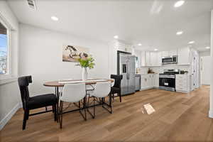 Dining room with recessed lighting, baseboards, visible vents, and light wood finished floors