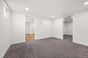 Below grade area featuring baseboards, carpet, and recessed lighting