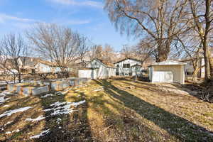 View of yard featuring a garden, an outbuilding, and a shed