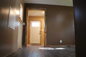 Entryway featuring wood finished floors and baseboards