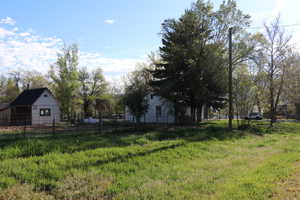 View of yard featuring fence