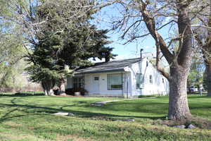 View of front facade with a front yard and a chimney