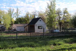 View of front of home featuring fence