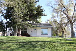 View of front of home featuring a front yard and a chimney