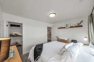 Carpeted bedroom with visible vents and baseboards