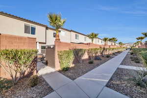 Exterior space featuring a residential view, fence, and stucco siding