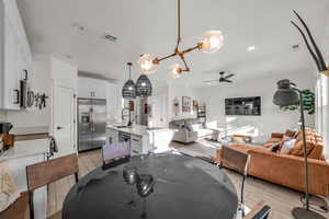 Dining space featuring a ceiling fan, recessed lighting, visible vents, and light wood-style floors