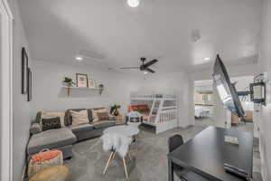 Carpeted living area with recessed lighting, attic access, and a ceiling fan