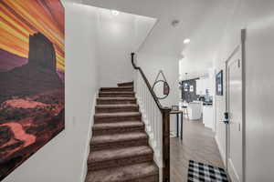 Stairway featuring baseboards and wood finished floors