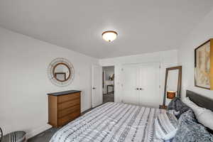 Bedroom with a closet, baseboards, and carpet flooring