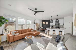 Living room with ceiling fan and visible vents