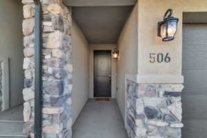 Entrance to property with stone siding