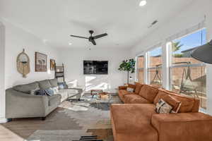 Living room with ceiling fan, visible vents, wood finished floors, and recessed lighting