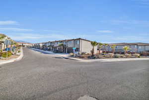 View of road with curbs, traffic signs, sidewalks, and a residential view