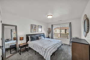 Carpeted bedroom featuring baseboards