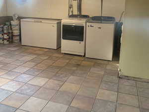 Below grade area featuring separate washer and dryer and fridge