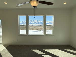 Interior space featuring a healthy amount of sunlight, baseboards, visible vents, and a mountain view