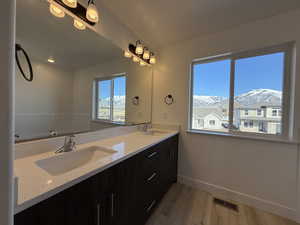 Full bathroom featuring visible vents, a sink, baseboards, and a mountain view