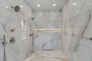 Bathroom featuring a marble finish shower