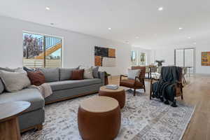 Living room featuring recessed lighting, a healthy amount of sunlight, and light wood finished floors