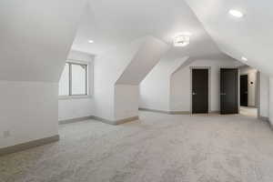 Additional living space featuring vaulted ceiling, carpet floors, recessed lighting, and baseboards