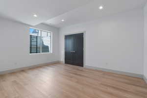 Spare room featuring recessed lighting, baseboards, and light wood finished floors