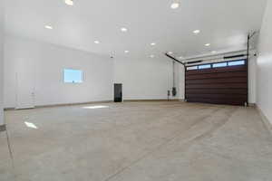 Garage featuring recessed lighting and baseboards