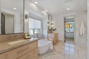 Full bathroom with marble finish floor, plenty of natural light, a sink, and recessed lighting