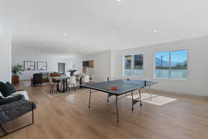 Playroom featuring light wood-type flooring, baseboards, and recessed lighting