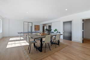 Dining room with baseboards, light wood finished floors, a healthy amount of sunlight, and recessed lighting