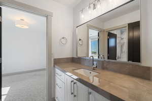 Bathroom with vanity and baseboards