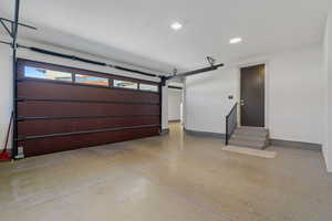 Garage featuring recessed lighting and baseboards