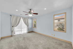 Carpeted empty room featuring visible vents, ceiling fan, and baseboards