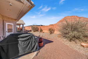 View of yard with a patio area, a fenced backyard, and a mountain view