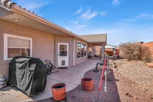 View of patio with fence and grilling area