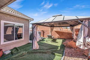 View of patio with fence and a gazebo