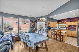 Dining area featuring recessed lighting, a notable chandelier, vaulted ceiling, and visible vents