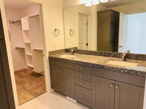 Full bathroom with double vanity and a sink