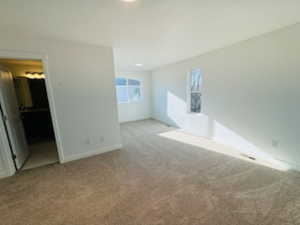 Interior space with carpet and baseboards