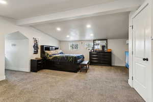 Bedroom featuring lofted ceiling, baseboards, carpet flooring, and recessed lighting