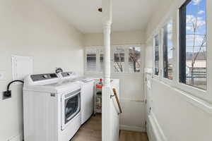 Washroom featuring laundry area, washer and clothes dryer, and light wood-type flooring