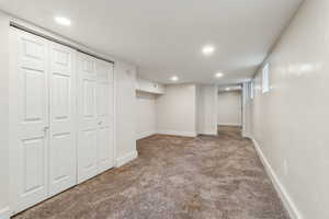 Finished basement featuring recessed lighting, carpet, and baseboards