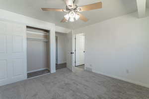 Main bedroom with visible vents, a closet, carpet flooring, and a textured ceiling