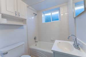 Full bath with  shower combination, toilet, and vanity