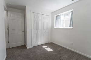 Bedroom 4 featuring carpet floors, baseboards, a closet, and a textured ceiling