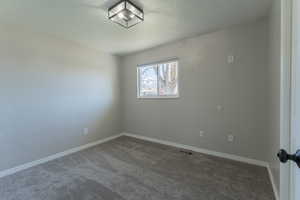 NEW Carpet bedroom 2 featuring baseboards, a textured ceiling, and visible vents