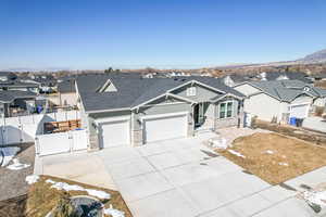 View of front of house featuring an attached garage, a gate, a residential view, and fence