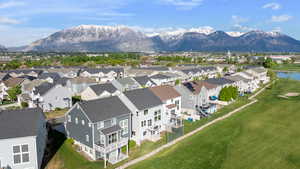 Drone / aerial view featuring view of golf course, a residential view, and a water and mountain view