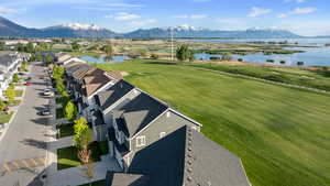 Aerial view with a water and mountain view and golf course view