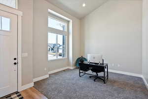 Office area with high vaulted ceiling, recessed lighting, and baseboards